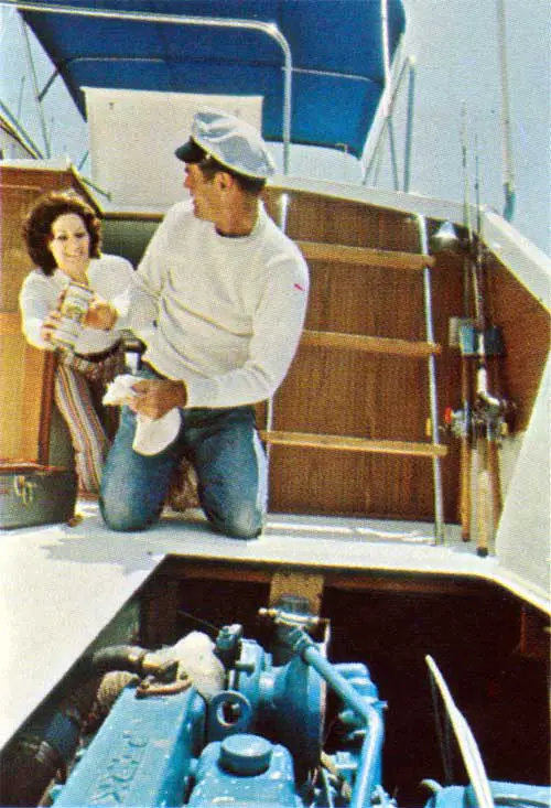 Maintaining the Engine on a Luhrs Boat Is Important. Here, the Skipper Is Served a Onlypia Beer for His Efforts by His First Mate.