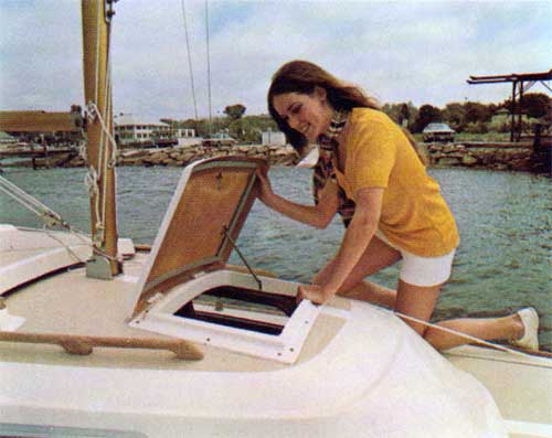 A Young Woman Checks Out The Cabin Hatch on the O'Day 22.