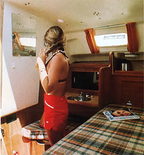 GGA Image ID # 2402b8d879 Young Woman in Cabin Getting Ready for Another Day of Sailing on the O'Day 32.