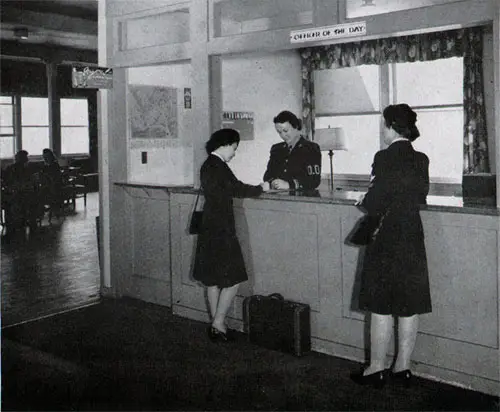 Officer-Of-The-Day From Her Desk at the Entrance of the Administration Building Coordinates Barracks’ Activity, Solves Immediate Problems, Acts in Emergencies, and Legalizes Action by Her Signature.