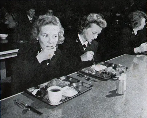 Two Waves Attack the Appetizing, Well-Balanced Meal on Their Traditional “Tin” Trays With an “All out” Enthusiasm.