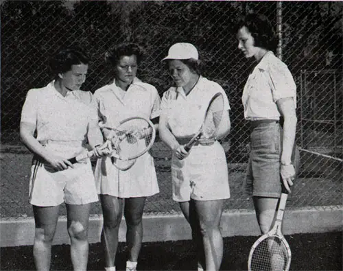 Tennis Enthusiasts Get a Few Pointers on Developing a Smashing Back-Hand Drive As Their Instructor Explains That Technique Eliminates a “Love” Game. I Hit the Mark Is Her Aim . . . in Proof That a Wave, Too, Can Find Her Target.