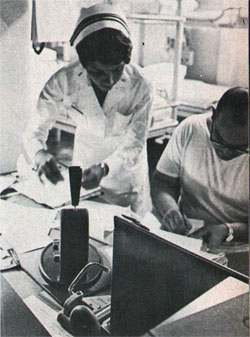 Navy Nurse Hill Checks Patients’ Medical Records With a Corpsman.