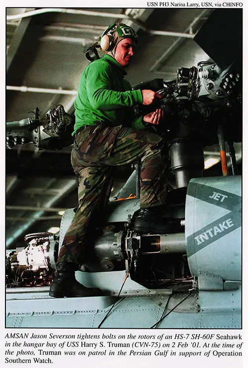 AMSAN Jason Severson tightens bolts on the rotors of an HS-7 SH-60F Seahawk in the hangar bay of USS Harry S. Truman (CVN-75) on 2 Feb 2001.