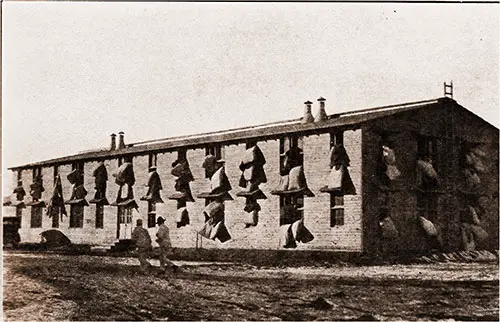 GGA Image ID # 18eea5377f Blankets and Mattresses Are Suspended Out the Barrack Windows of the 302nd Light Artillery During Morning Drill.