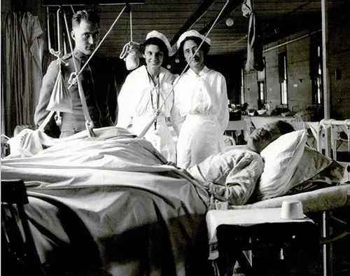 GGA Image ID # 1908a1b5e5 Patient at the Camp Pike Orthopedic Ward being Attended to by the Orthopedic Surgeon and Two Nurses. nd, c. 1918.