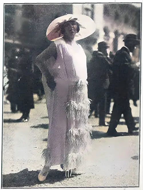 Madeleine Vionnet’s Sporting Dress Is Made of White Crêpe Satin and Is Trimmed With Narrow Flowers and Ribbon. The Skirt Reaches the Ankle.