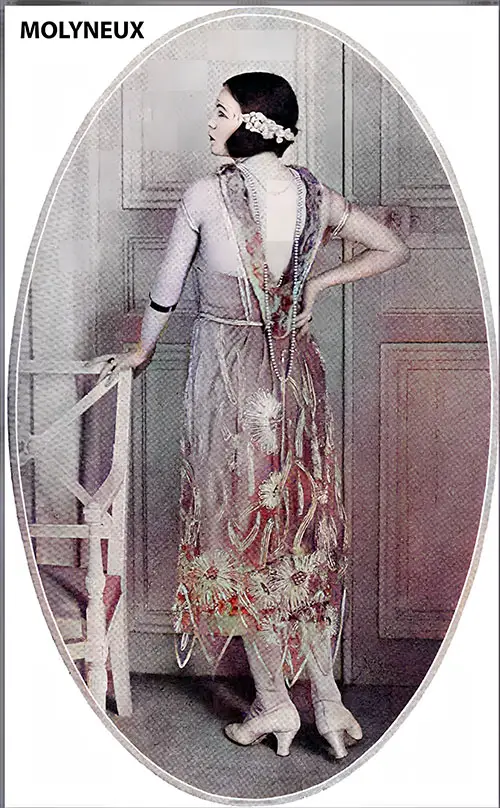 This Exquisite Gown From Maison Molyneux of Pearl-Gray Satin Embroidered With Tulle in Silver Gray Is Unusual for Shoulder Straps and the Petal-Like Cut of the Overskirt. The Novel Headdress Is Worth Noting.