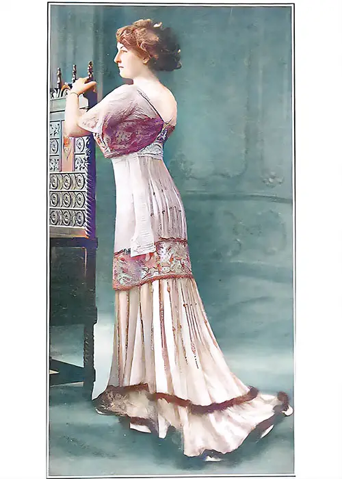 Splendid Evening Gown of Changeable Moire Vieled With Net Embroidered with Many Colored Round Beads.