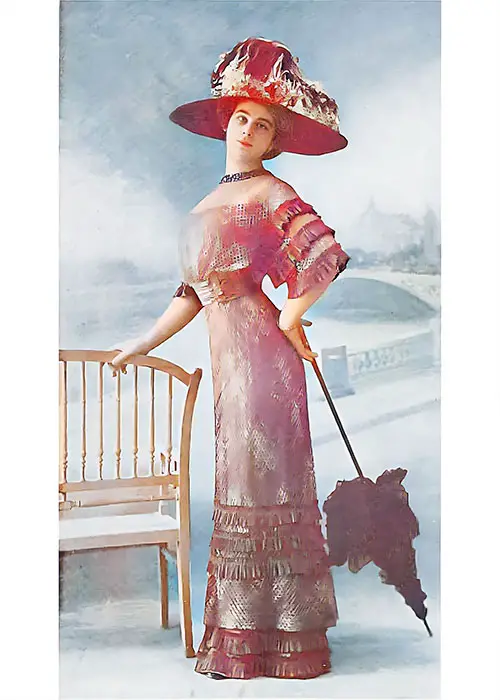 Gown of Changeable Taffeta Covered with the New Printed Filet Net and Trimmed With Taffeta Pleatings.