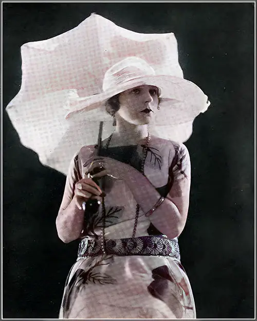 This Charming Costume Evokes Memories of a Wide Lawn and Sunny Brack. The Design Features Cheerful Apples on a Crêpe de Chine Frock Created by Molyneux, Which Mrs. Dean Bushby Wears.