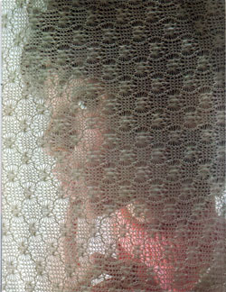 Bright-eyed young lady screened by a knitted fabric produced by Bangor Punta - 1968 Annual Report