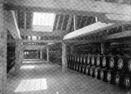 A PORTION OF THE SALT-MEAT STORE SHOWING BARRELS FILLED WITH SALT PORK.