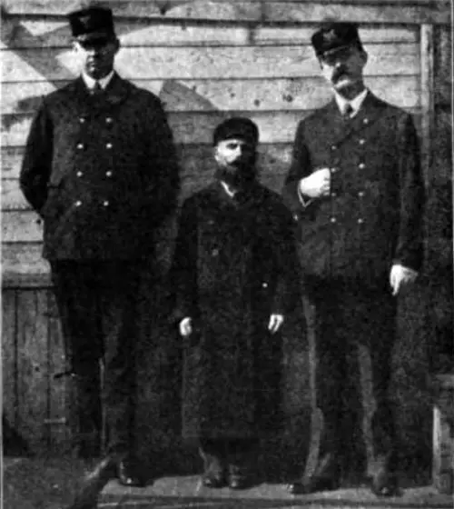 Photo 09 - An Immigrant Standing With Ellis Island Inspectors