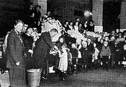 Commissioner Wallis and Immigrants at Ellis Island at Christmas