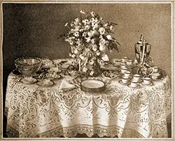 GGA Image ID # 20302567e1 Wedding Buffet Table Set Up with Plates, Napkins, Punch Bowl and Glasses, Coffee and Coffee Cups, with a Center Floral Piece.