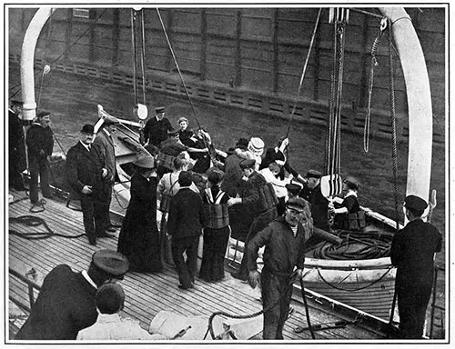 Sailors and stewardesses of a North German Lloyd liner practicing lifeboat drill at the company's pier