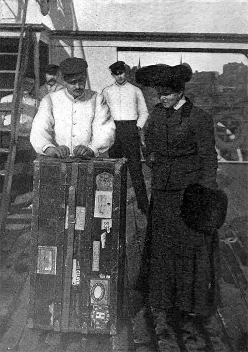 Porter Assists Passenger with Steamer Trunk, The Book Lover's Magazine, May 1904.