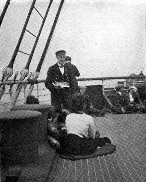 Steward Serves Lunch for the Loungers on Deck