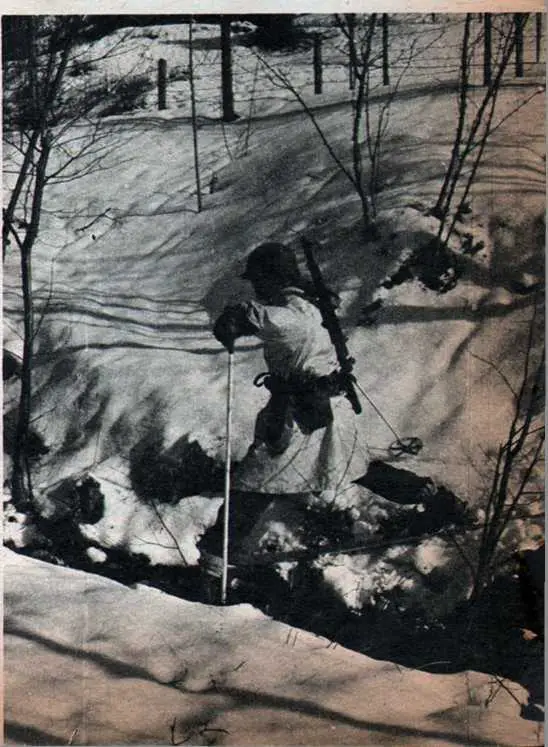 Pfc. William C. Douglas of Lake Forest, III., carefully makes his way across a mountain stream on his skis.