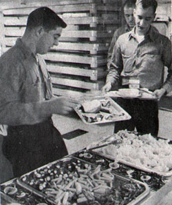 Carrier crewmen help themselves to food