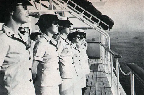 Navy nurses stand formation as USS Repose enters Subic Bay.