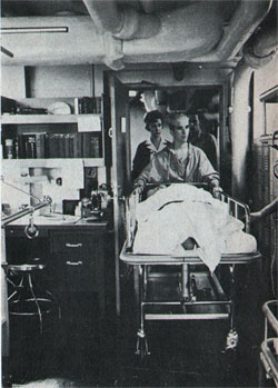 Navy nurse Crosby escorts patient from recovery ward.
