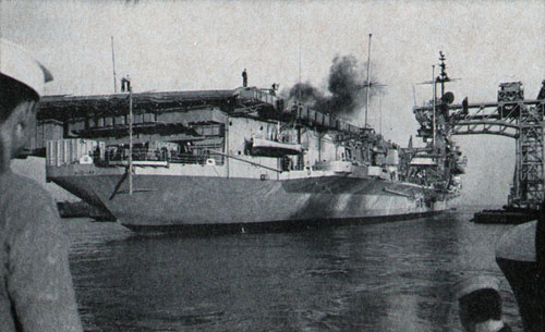 ON HER WAY to decommissioning for a three-year overhaul, Midway slips under a crane to berth at Hunter's Point.