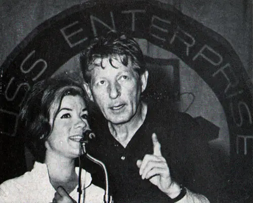 Danny Kaye and Vikki Carr sing together	during a show aboard Enterprise.