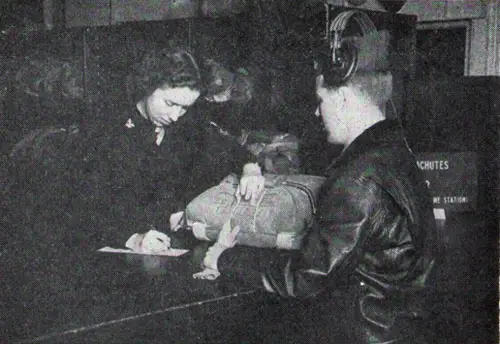 WAVE issues a parachute to one of the pilots at Naval Auxiliary Air Station