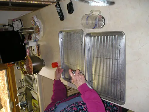 Preparing the Baking Pans by Spaying on a Non-Stick Oil.