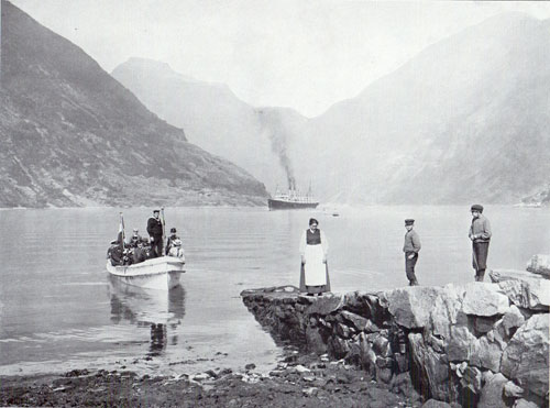 Photo 091: The SS Auguste Victoria in Merok, Geiranger Fjord, Norway - A tender is arriving with load of passengers.