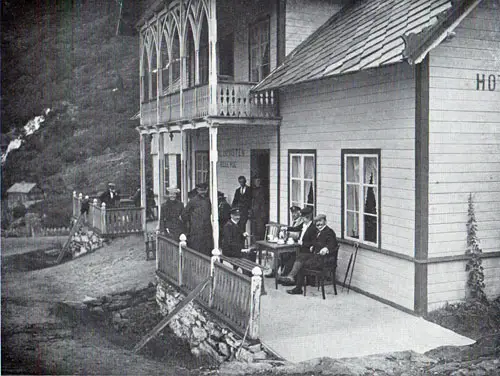Photo 105: View of the hotel guests relaxing on the front porch. 