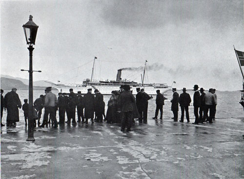 Photo 088: A crowd gatheres at the pier watching the SS Meteror at the Pier at Aalesund