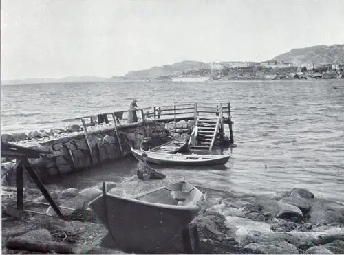 Photo 127: The SS Meteor at Bergen showing three Norwegian women at the dock relaxing. 