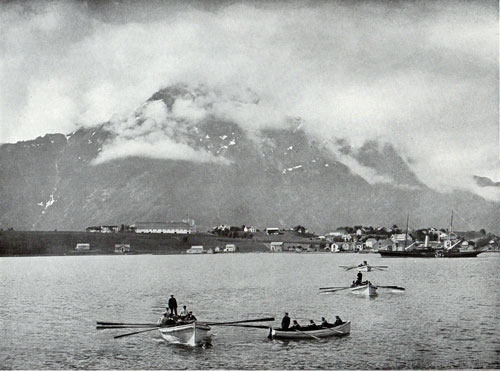 Photo 043: View of Naes Harbor, Rowboats and larger Steamship in foreground