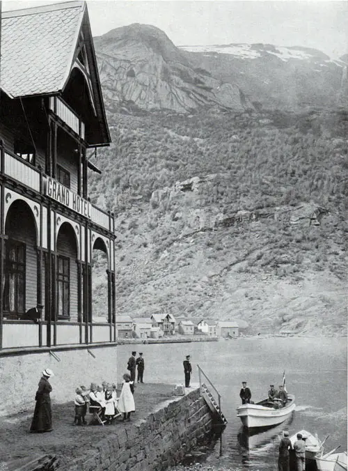 Photo 035: Grand Hotel at Odda showing visitors arriving by small water craft.