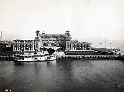 United States Immigration Station, Ellis Island, New York Harbor, with a Boat Docked in Front of the Main Building, 1910.