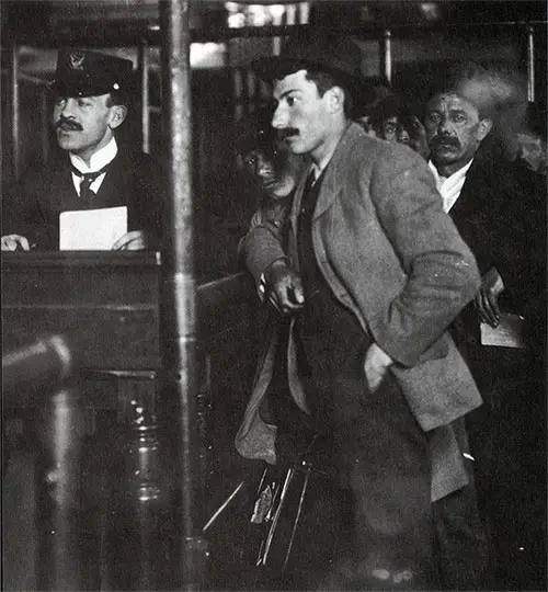 Immigrant Responding to Questions at an Inspector's Desk at Ellis Island.