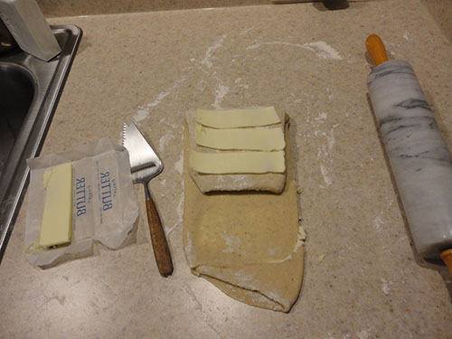 Step 5: Folding and Adding More Butter To the Kringle Dough. the Cheese Cutter Is Used To Slice off the Butter.