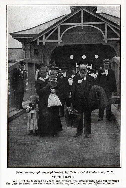 Immigrants at the Gate. With tickets fastened to coats and dresses, the immigrants pass out through the gate to enter their new inheritance, and become our fellow citizens. From Stereograph. © 1904 Underwood & Underwood, NY.