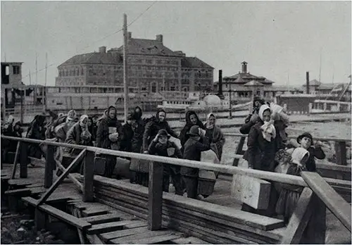 Landing at Ellis Island—View Shows Emigrants Coming up the Board-Walk From the Barge