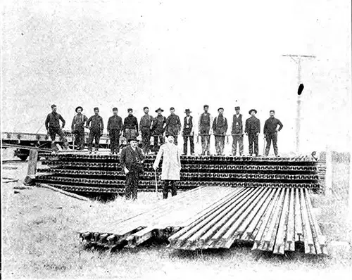 Foreign Workmen Unloading the First Car of Steel on the Grand Trunk Pacific.