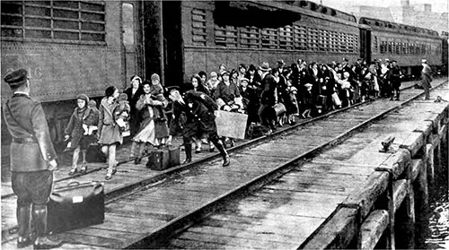 Deportees and Repatriates Leaving the Transcontinental Train at Jersey City on Their Way to Ellis Island.