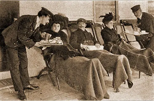 First Class Passenger Enjoy the Luxury of Relaxing on a Steamer Chair Covered With a Steamer Rug To Keep Them Warm and Cozy While Being Served Sandwiches by the Steward.