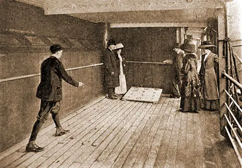 Passengers Enjoy a Game of Bull Board on a Sheltered Promenade Deck.