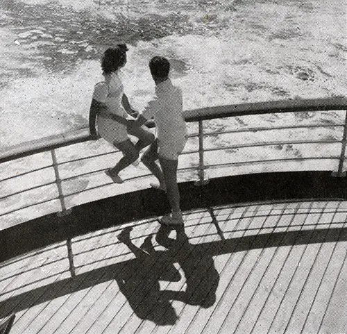 A Young Couple Watches the Waves Created by the SS Ile de France Propellers.