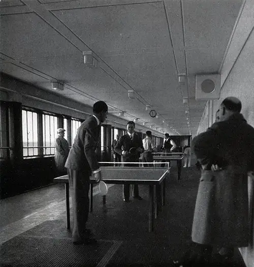 Passengers Play Table Tennis on the Promenade Deck.