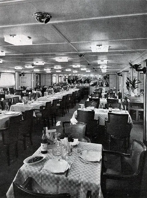 In the Delightful Dining Room, 65 Feet Long by 30 Feet, Decorated in Soft Green, Passengers Enjoy Delicious Cuisine.