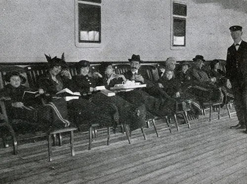 First Class Passengers Relaxing on the Promenade Deck With Steamer Chairs Along With Steamer Rugs for Warmth on a White Star Line Ocean Liner Circa 1909.